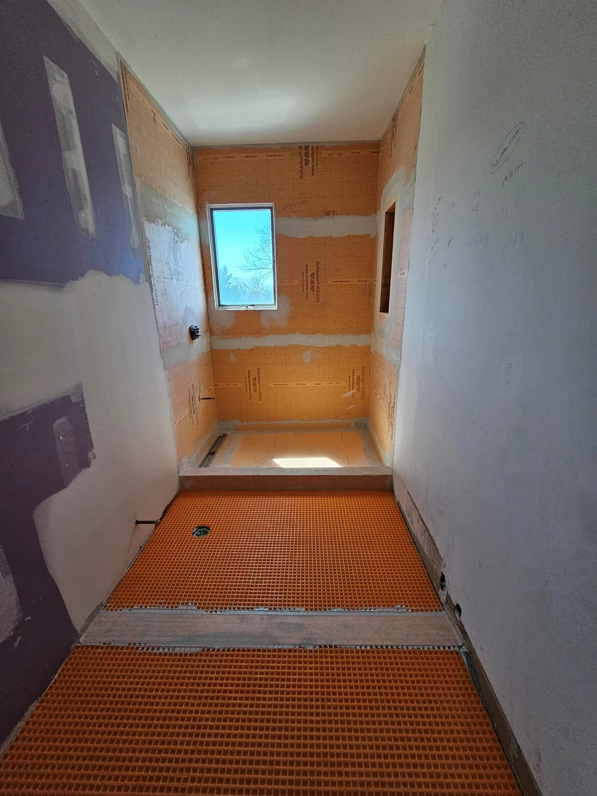Finished Newburgh bathroom remodel with walk-in subway tile shower, black framed glass door, and black hex tile floor - photo 3