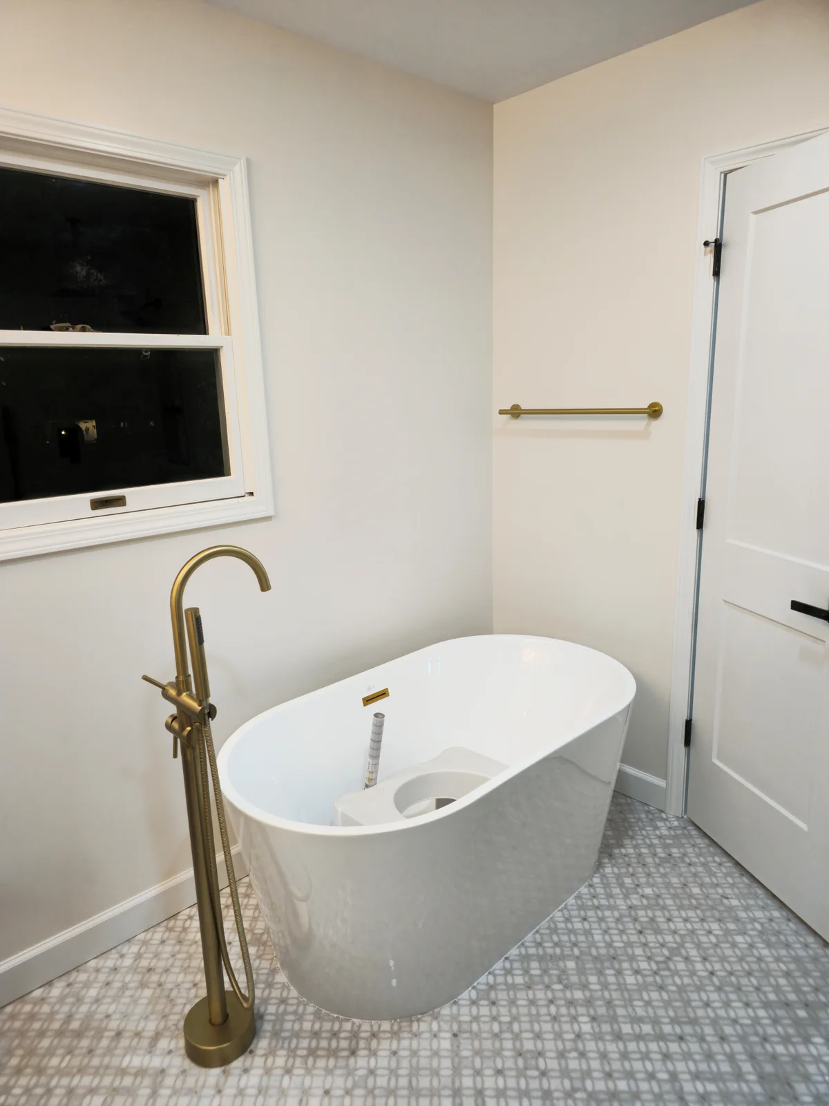 Finished Evansville bathroom remodel with dark green double vanity, arched mirrors, brass sconces, and freestanding tub - photo 2