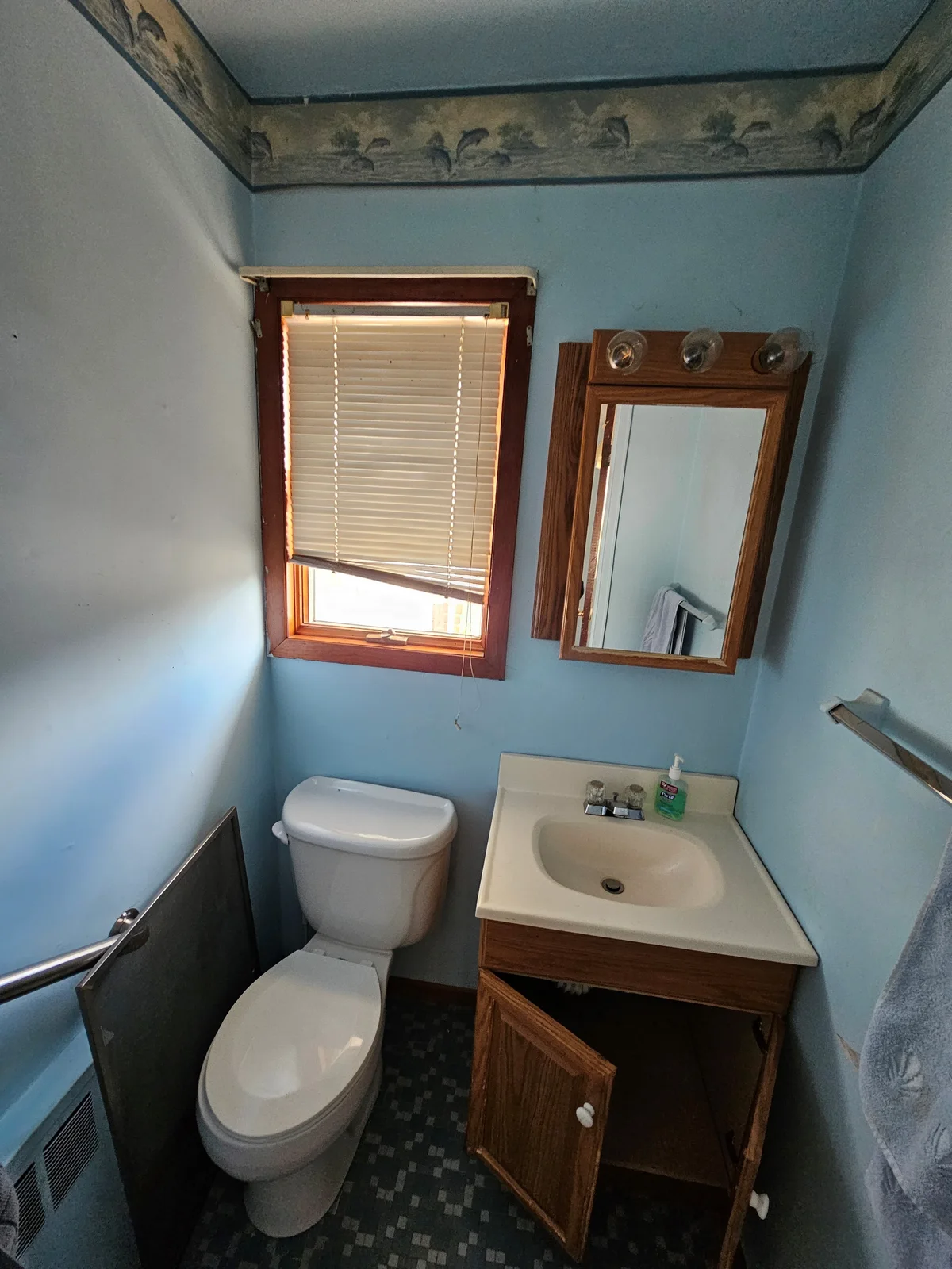 Finished Evansville half-bath remodel with dark green walls, pedestal sink, gold faucet, backlit mirror, and new toilet - photo 1