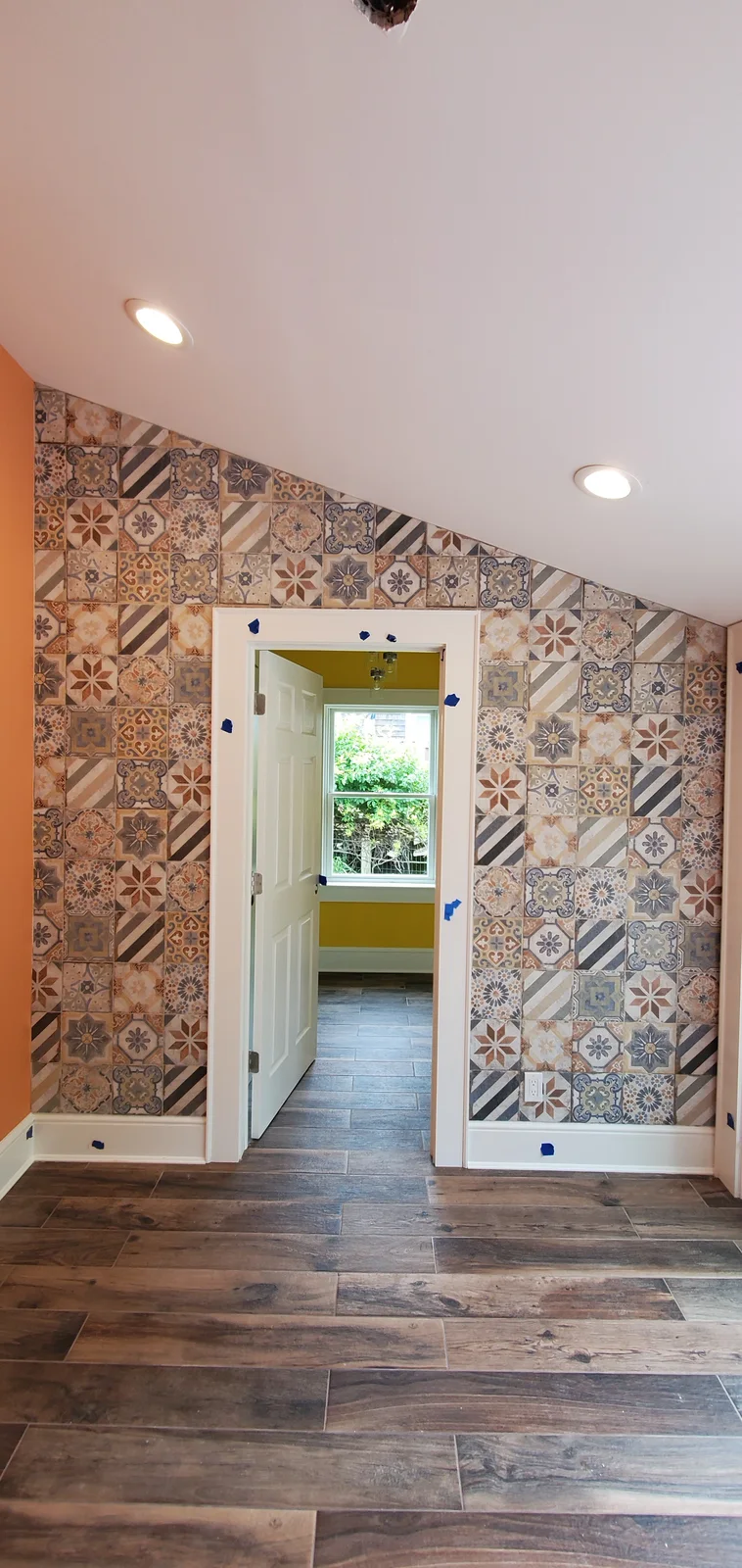 Finished wood-look tile flooring installed throughout a bright remodeled interior